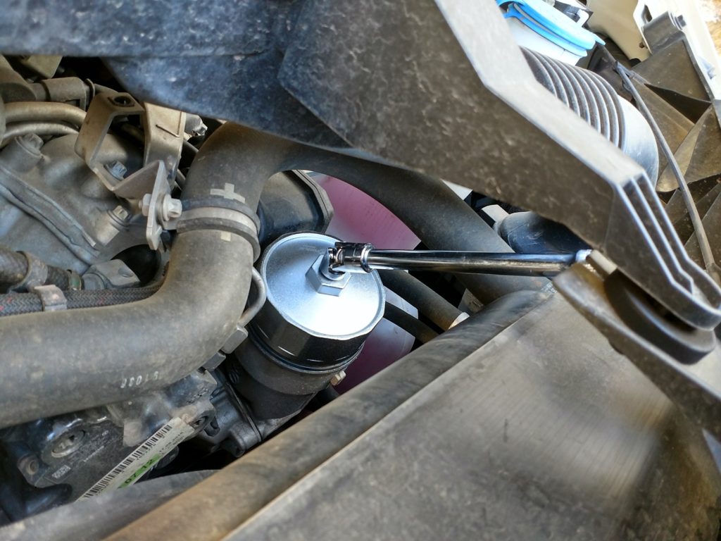 Loosen the oil filter housing