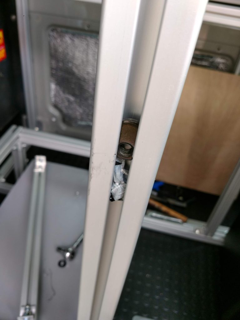A trick for locating the T-nuts in vertical slots, insert a wad of tape to hold it in place